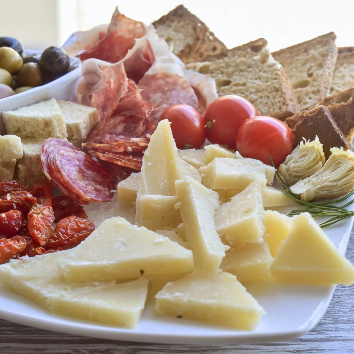 Enjoy a tantalizing Rustic Italian Farmhouse Board, featuring artisanal cheeses, cured meats, and crusty bread.
