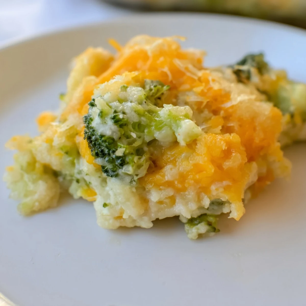 Mouthwatering close-up of cheesy, savory broccoli casserole bites; they're baked to perfection.