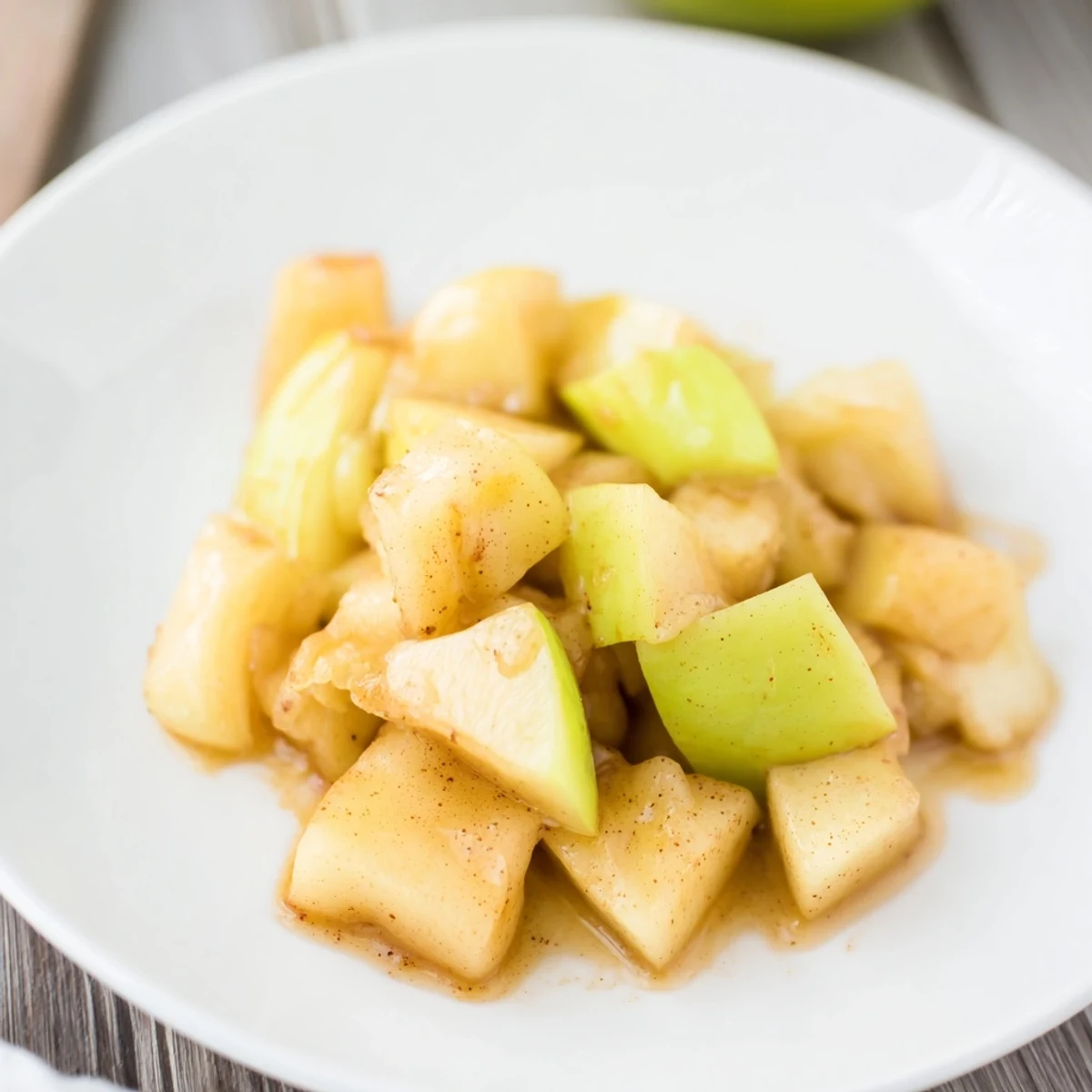 Warm Slow Cooker Stewed Apples, featuring honey and lemon, look delicious served over oatmeal.