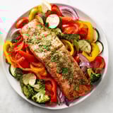 Tender salmon sheet pan bake with colorful veggies, a healthy and easy weeknight meal.