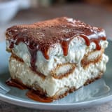 Hojicha Tiramisu layered with cocoa-dusted mascarpone cream and dipped ladyfingers in a rustic dish.