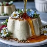Silky honey lavender panna cotta with floral aroma and a golden honey drizzle, served in a glass ramekin.