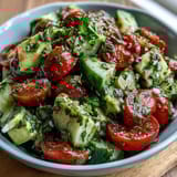 Fresh cucumber tomato avocado salad with lemon dressing, vibrant and colorful for a healthy lunch
