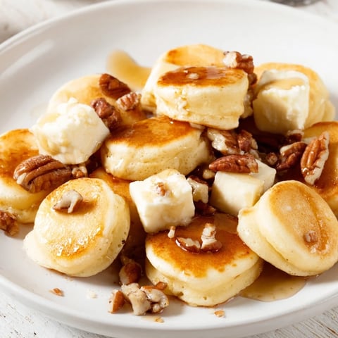 Golden-brown Pancake Brie Bites, a delightful appetizer with warm, melted brie inside.