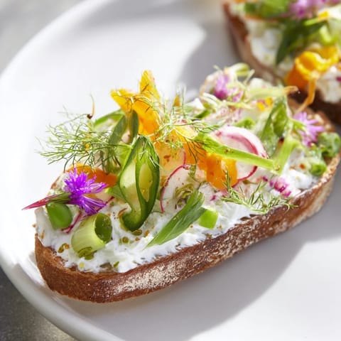 Vibrant image of Fresh Meadow-Inspired Garden Vegetable Tartines showcases a lovely, open-faced veggie sandwich.