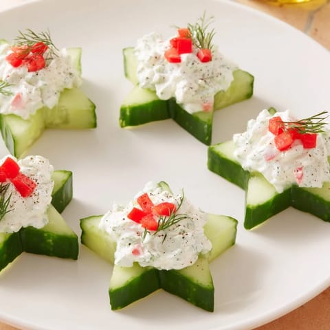 These festive Cucumber and Dill Christmas Stars sparkle with creamy cheese atop crisp cucumber slices.