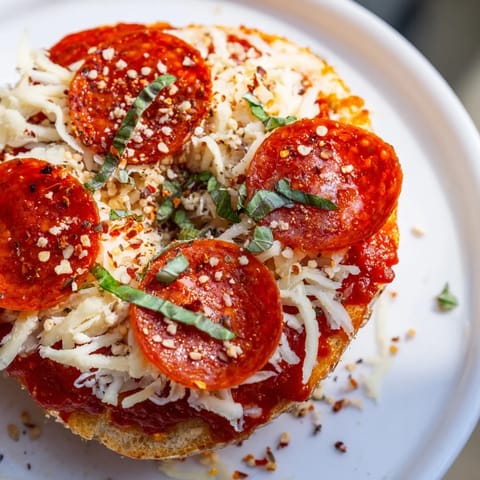 Golden-toasted Mini Pepperoni Pizza Bagels, ready to eat, featuring a perfect melty mozzarella layer.