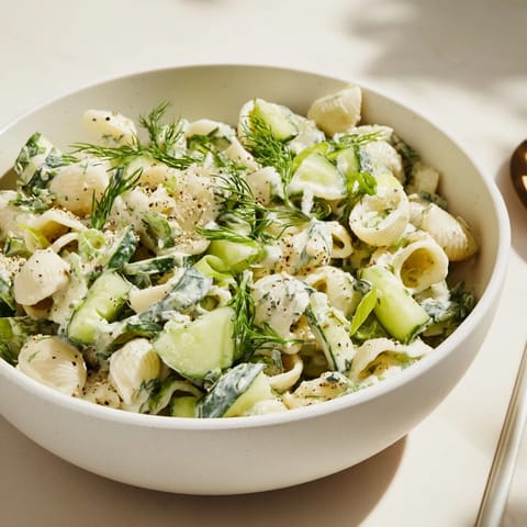 Chilled Cucumber Crunch Pasta Salad with small shells, diced cucumbers, and green onions ready for a summer picnic.