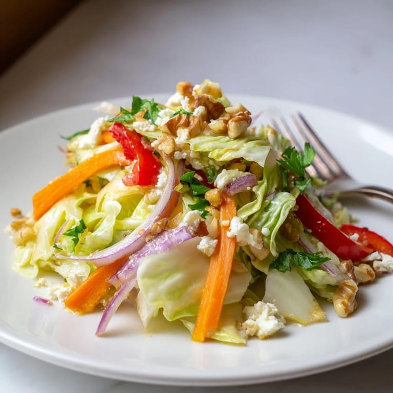 This Cooked and Loved Cabbage Salad glows with a warm, sautéed crunch, topped with toasted walnuts and feta cheese for a nourishing weeknight side.  