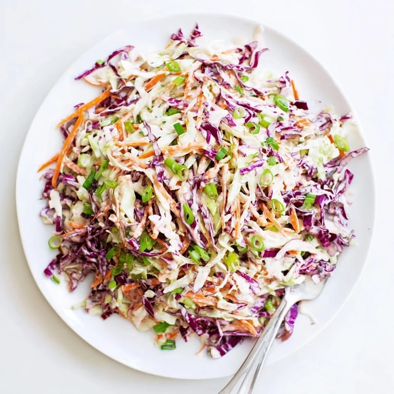 A chilled bowl of Best Cabbage Coleslaw, a crisp refreshing side for picnics, sandwiches, or summer barbecue gatherings.