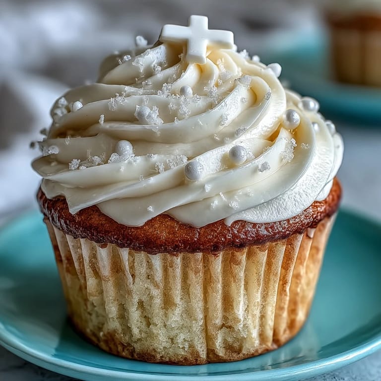 Elegant communion cupcakes crowned with creamy frosting and delicate fondant crosses.